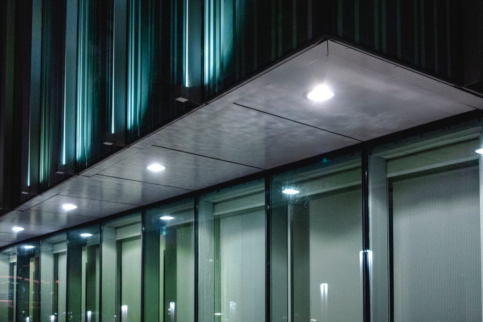 Exterior lighting installed across a commercial building at dusk